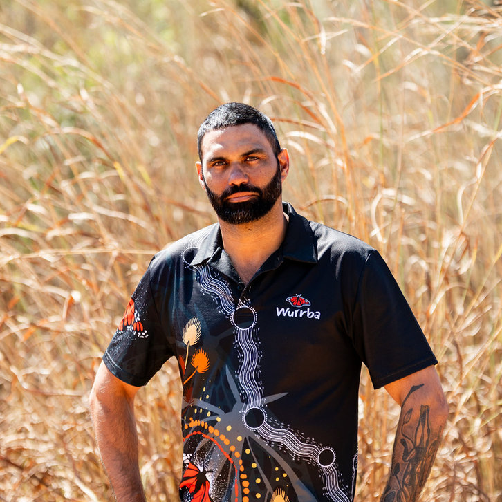 Raphael Clarke, Managing Director of Wurrba, standing in spear grass